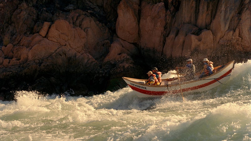 A Grand Canyon dory punching through Colorado River whitewater
