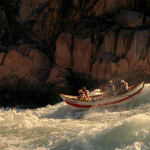 A Grand Canyon dory punching through Colorado River whitewater