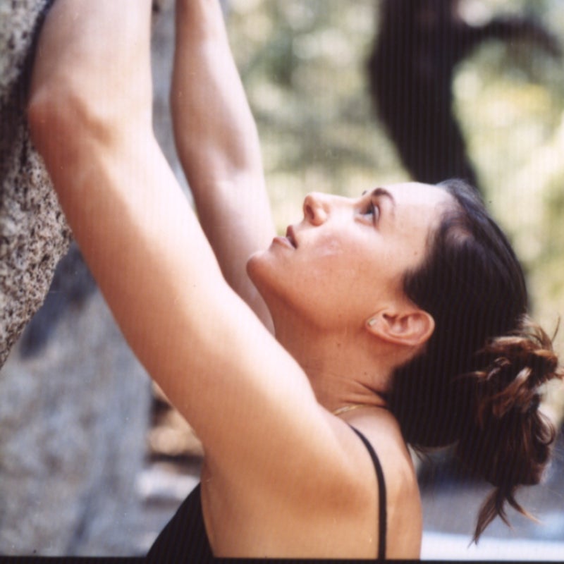 Steph Davis eyes a tricky bouldering problem in Yosemite.