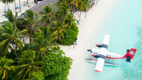 seaplane on a white sand beach if you book with a travel agent