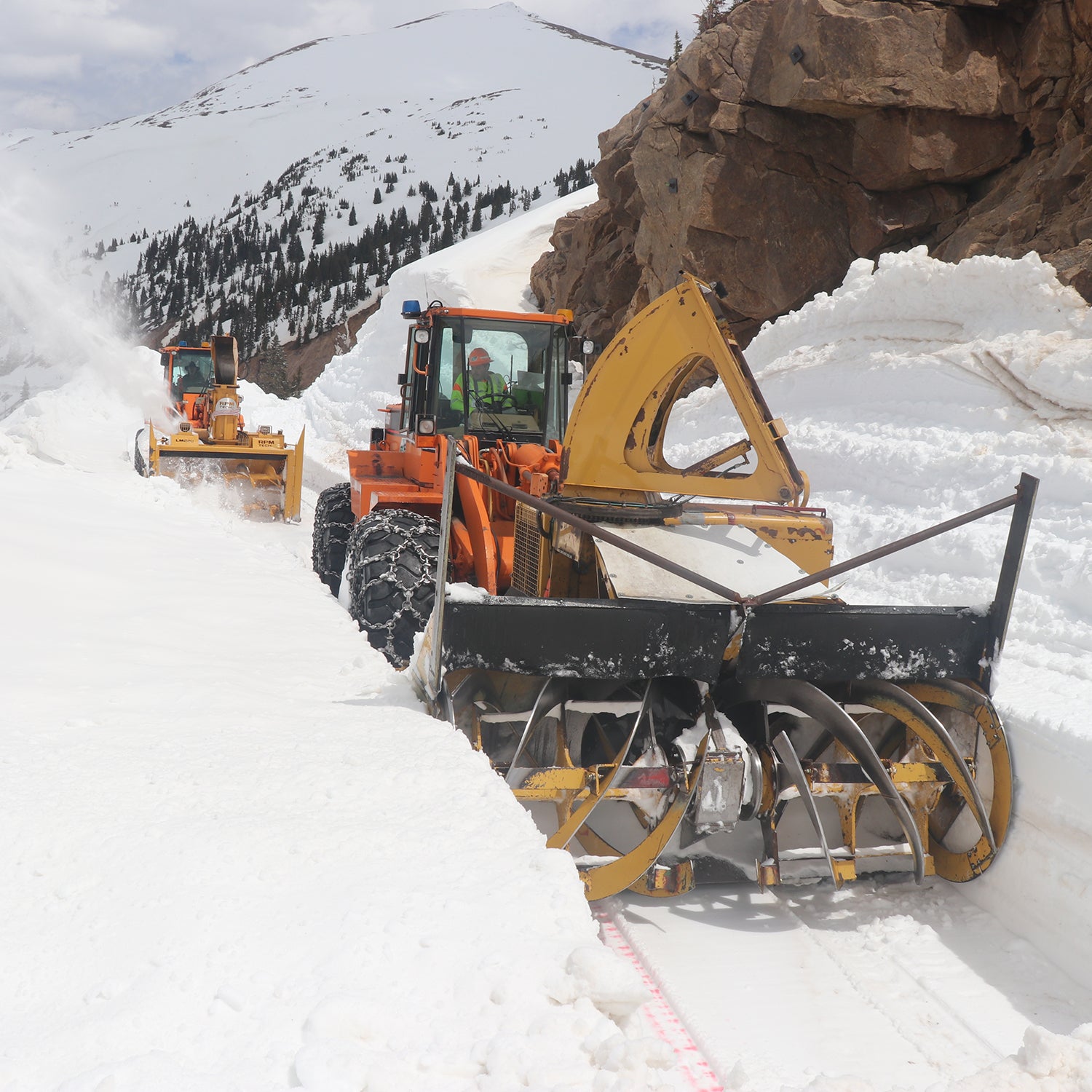 CDOT crews work to remove snow from Highway 82 below the summit.