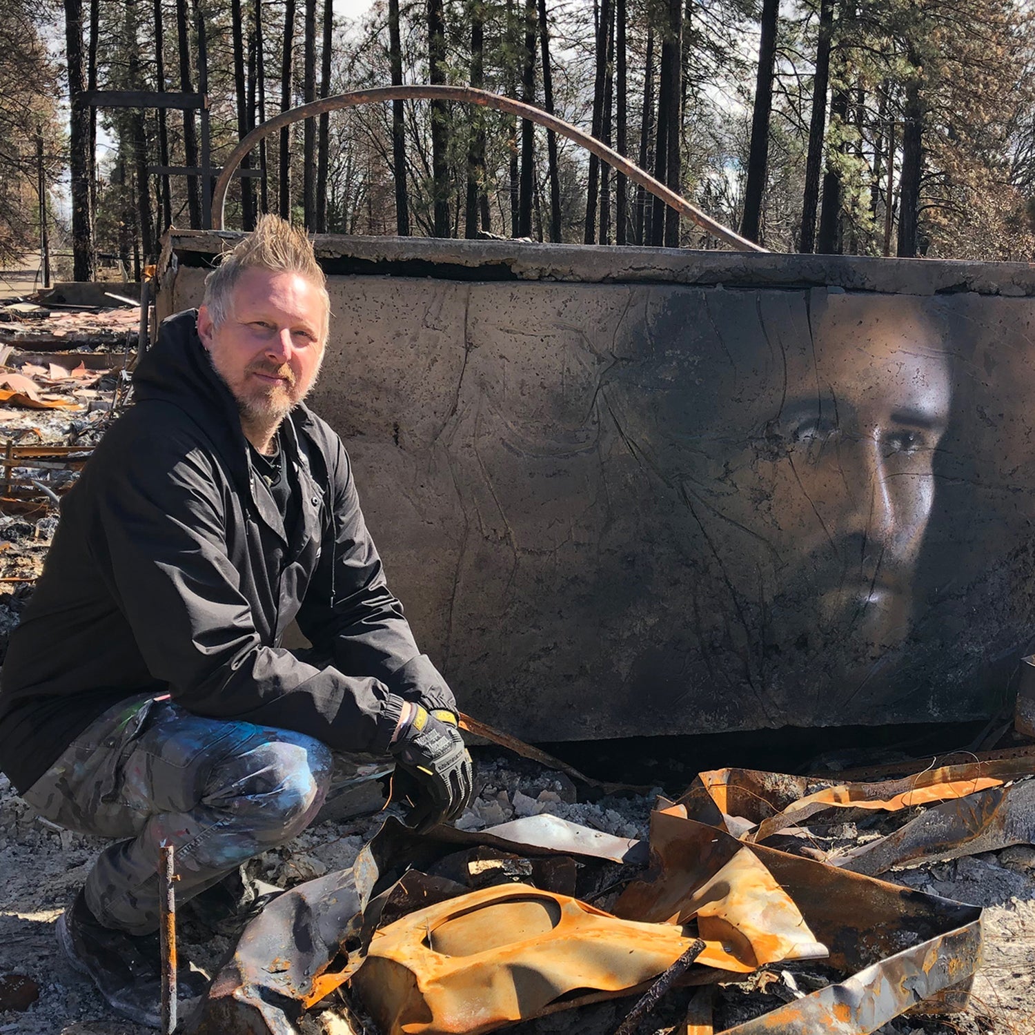 Shane Grammer in front of one of his murals in Paradise, California.