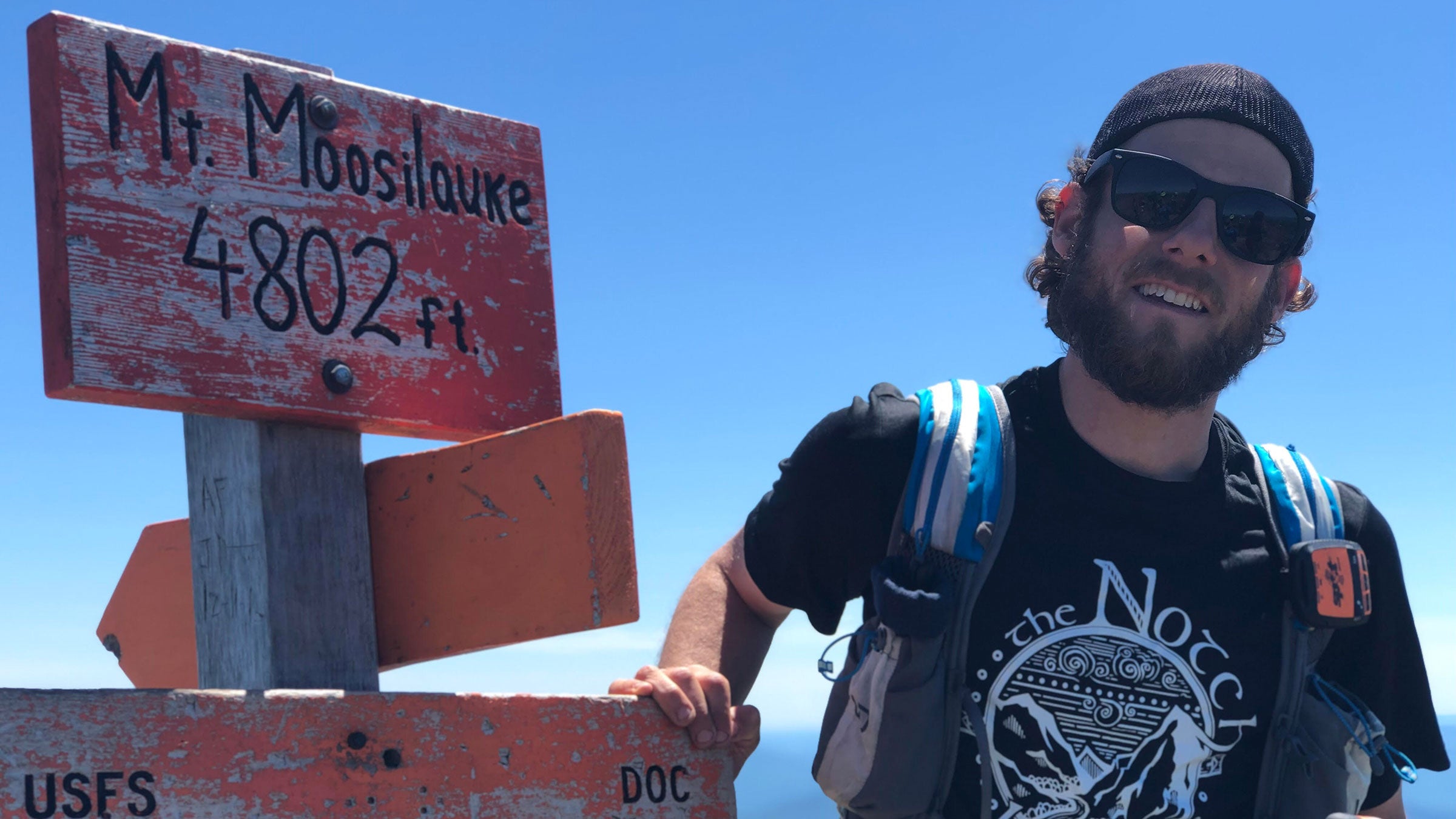 Philip Carcia soaks in the moment as he summits Mou t Moosilauke, his 576th and final peak of the single-year grid.