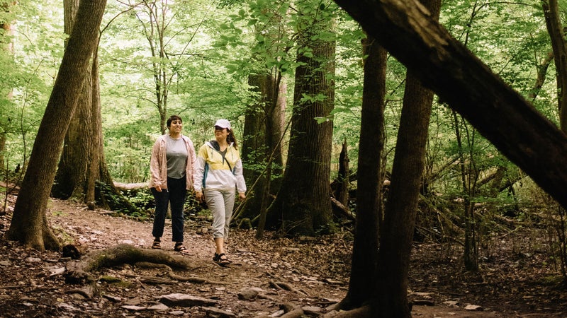 Adriana (left) in Eddie Bauer Resolution Tank Top, Guide Pro Pants, and Ventatrex Packable Jacket. Luz (right) in Eddie Bauer Momentum Light Jacket, Guide Pro Capris, and UPF Cap.