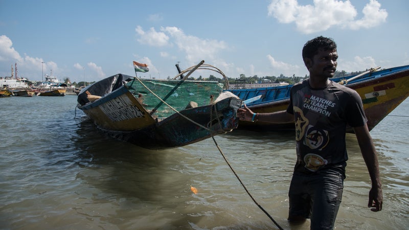 A fisherman pulls MV Halen, the boat Chau used to reach North Sentinel.