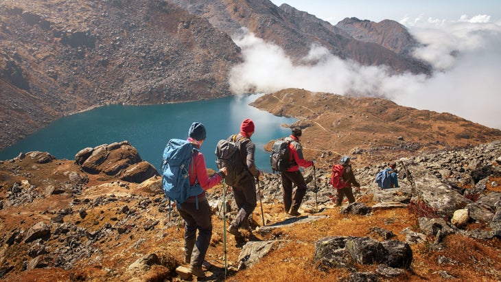 Backpacking tourists descend from a mountain, the easiest way to treat altitude illness.