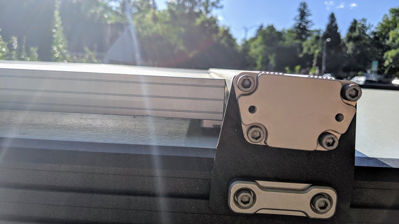 Mounting solar panels with roof bars is one way to go, just make sure the face of the panel sits below the top of the bar, so you can still carry loads.