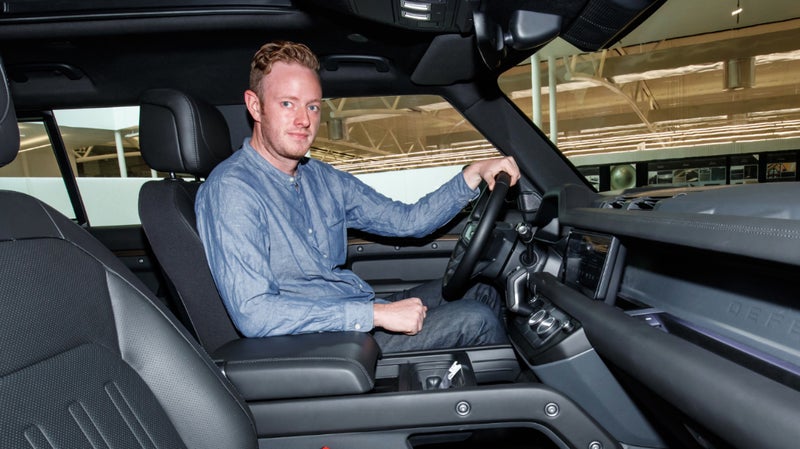 The author sitting in the new Defender, at the Land Rover Design Center, back in July.