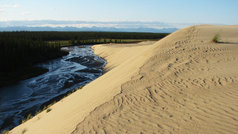 Ahnewetut Creek and nearby dunes glow in the setting sun.