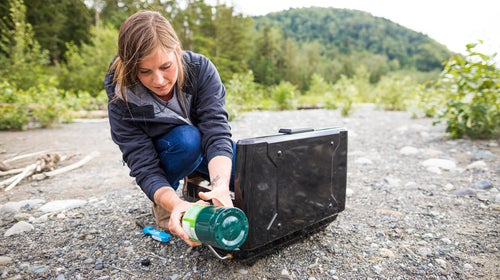 Woman setting camping stove