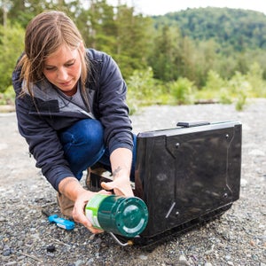 Woman setting camping stove