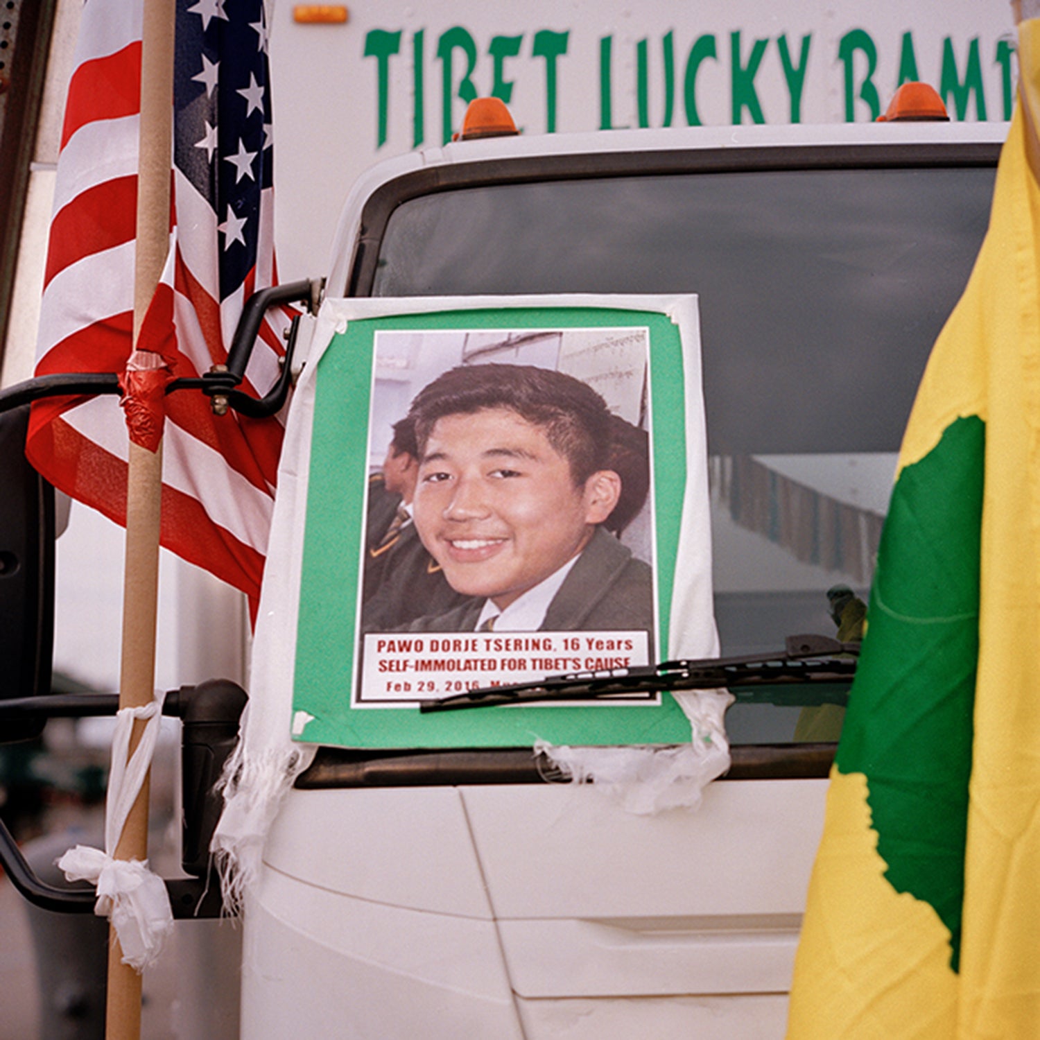 An image of self-immolator Dorjee Tsering, displayed at a Tibetan rally in New York City; right, Dorjee’s parents, Nyima Yangzom and Thupten Tashi (seated), in Asansol, India