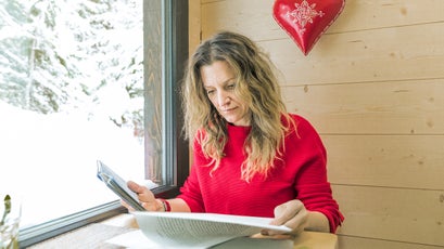 Sarah Marquis in her house, reading the notes she wrote while preparing her book, Wild By Nature