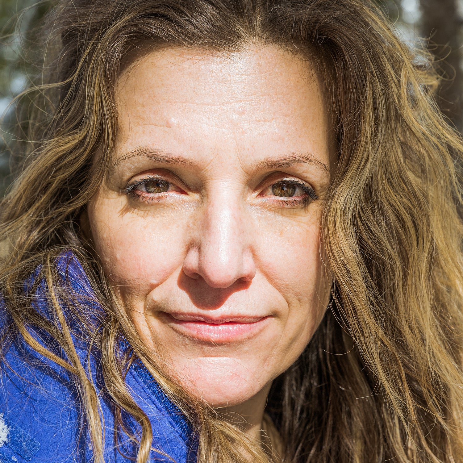 Sarah Marquis posing in front of her house in Switzerland