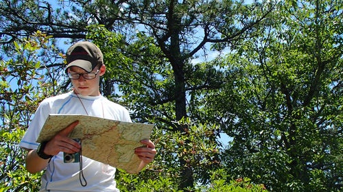 Man in the woods with map