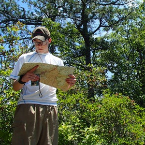 Man in the woods with map