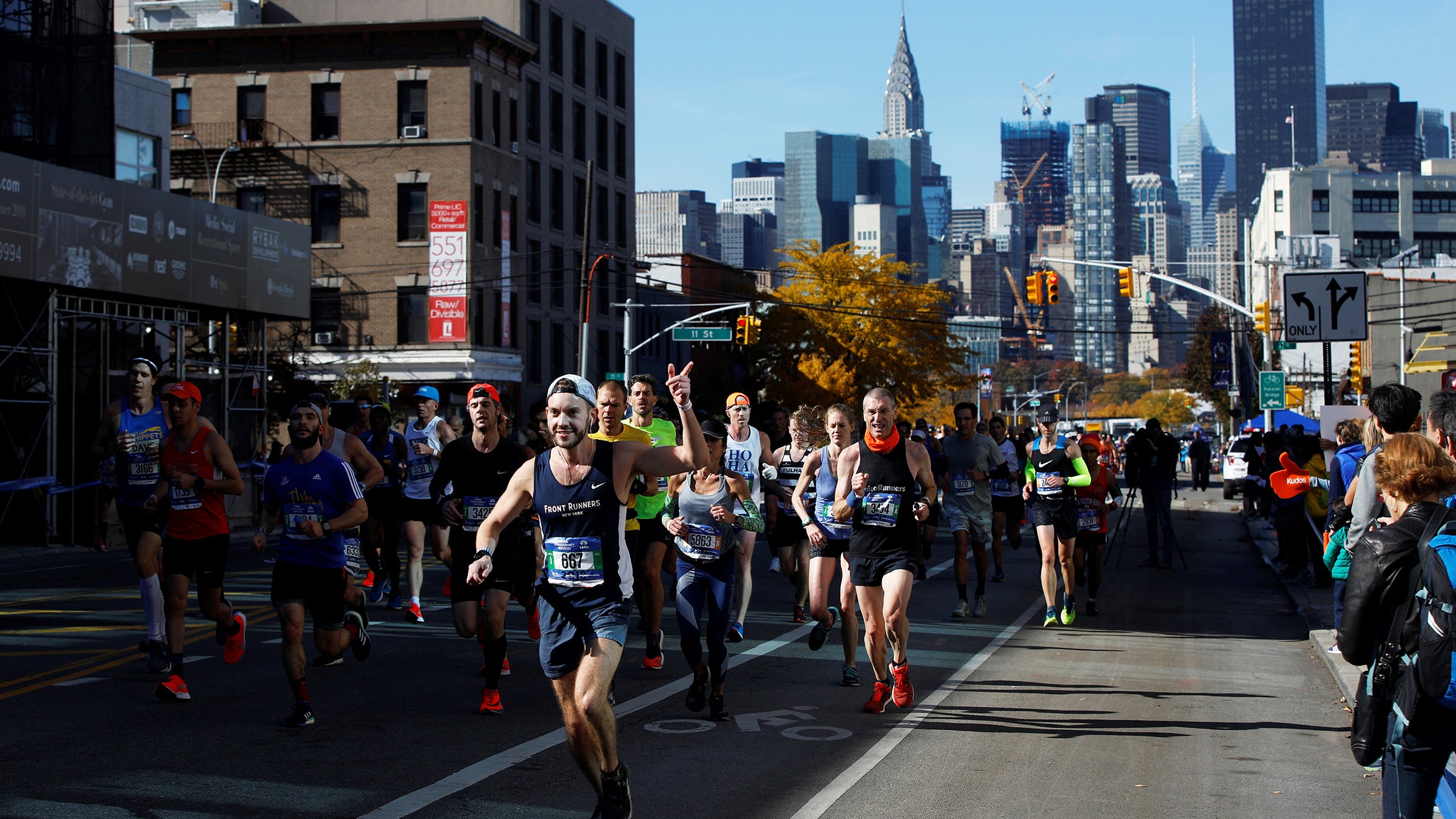 Runners jog through Queens during the 2018 New York City Marathon.