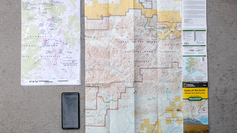 My three standard map types (clockwise from top left): custom-detailed maps on 11-by-17-inch paper, a commercial overview map, and digital maps and layers on a smartphone