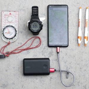 The author’s preferred system of navigation equipment: a magnetic compass, GPS watch, smartphone with a GPS app (plus a charger on longer trips), and two pens