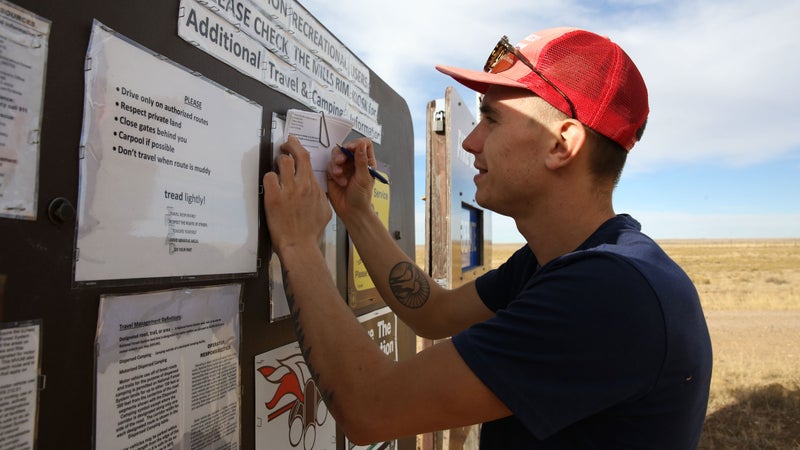 A climber filling out the land-usage survey at the Smokey Bear sign at the entrance to Mills Canyon. If you鈥檙e visiting, make sure to stop and let the Forest Service know why you鈥檙e there and what amenities you鈥檇 like to see in the future.