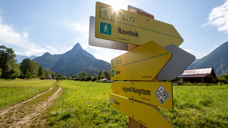 A signpost on stage 14 of the Juliana, just outside the ski town of Bovec. Mount Svinjak’s iconic pyramidal summit rises in the background.
