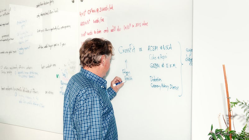 Glassman writing on a whiteboard