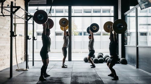 Men Exercising With Barbells In A Crossfit Box