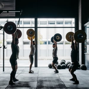 Men Exercising With Barbells In A Crossfit Box