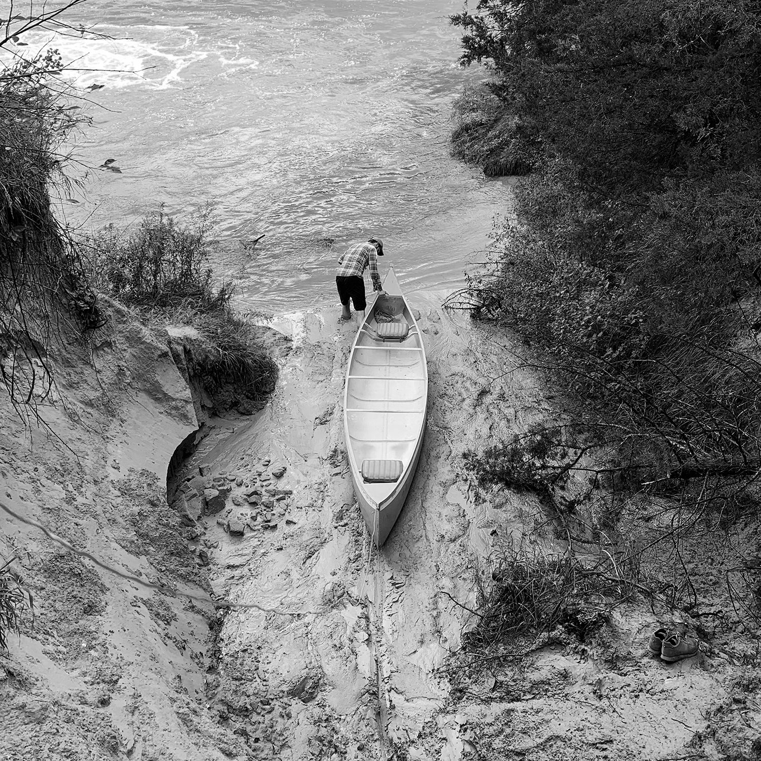 The author dragging his canoe onto the Dismal River