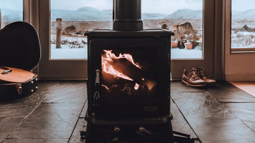 Wood burning fireplace in snow cabin