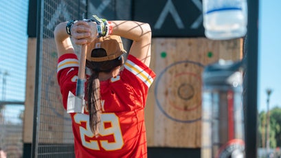 A festivalgoer tries her hand at axe throwing