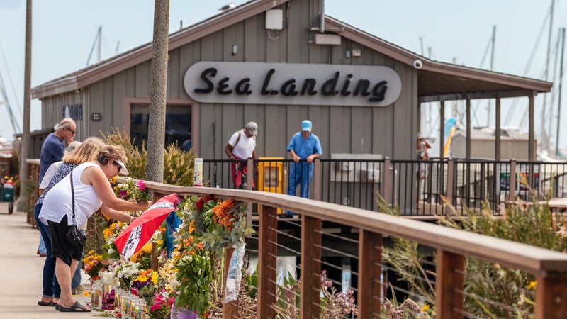 Mourners leaving flowers and memorabilia at the Sea Landing dock, home of the commercial dive boat Conception, in Santa Barbara on September 3, 2019
