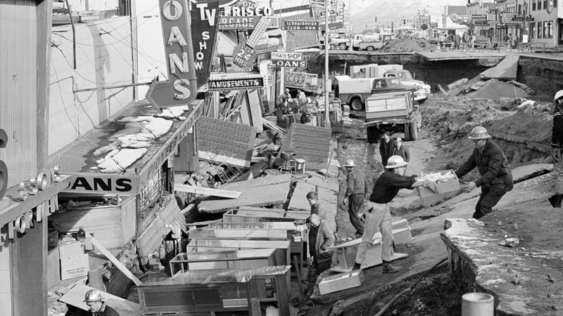 Small business owners clear salvagable items and equipment from their earthquake-ravaged stores on Fourth Avenue in Anchorage, Alaska, in the aftermath of the 1964 earthquake.
