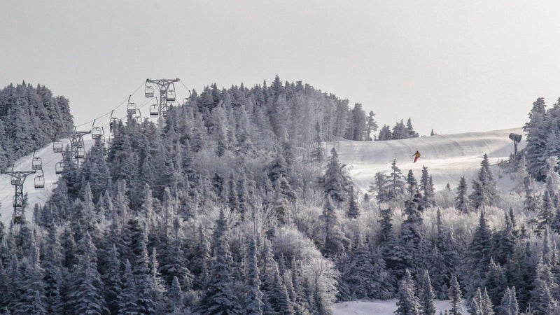 A skier coming down Saddleback Mountain before its closure in 2015