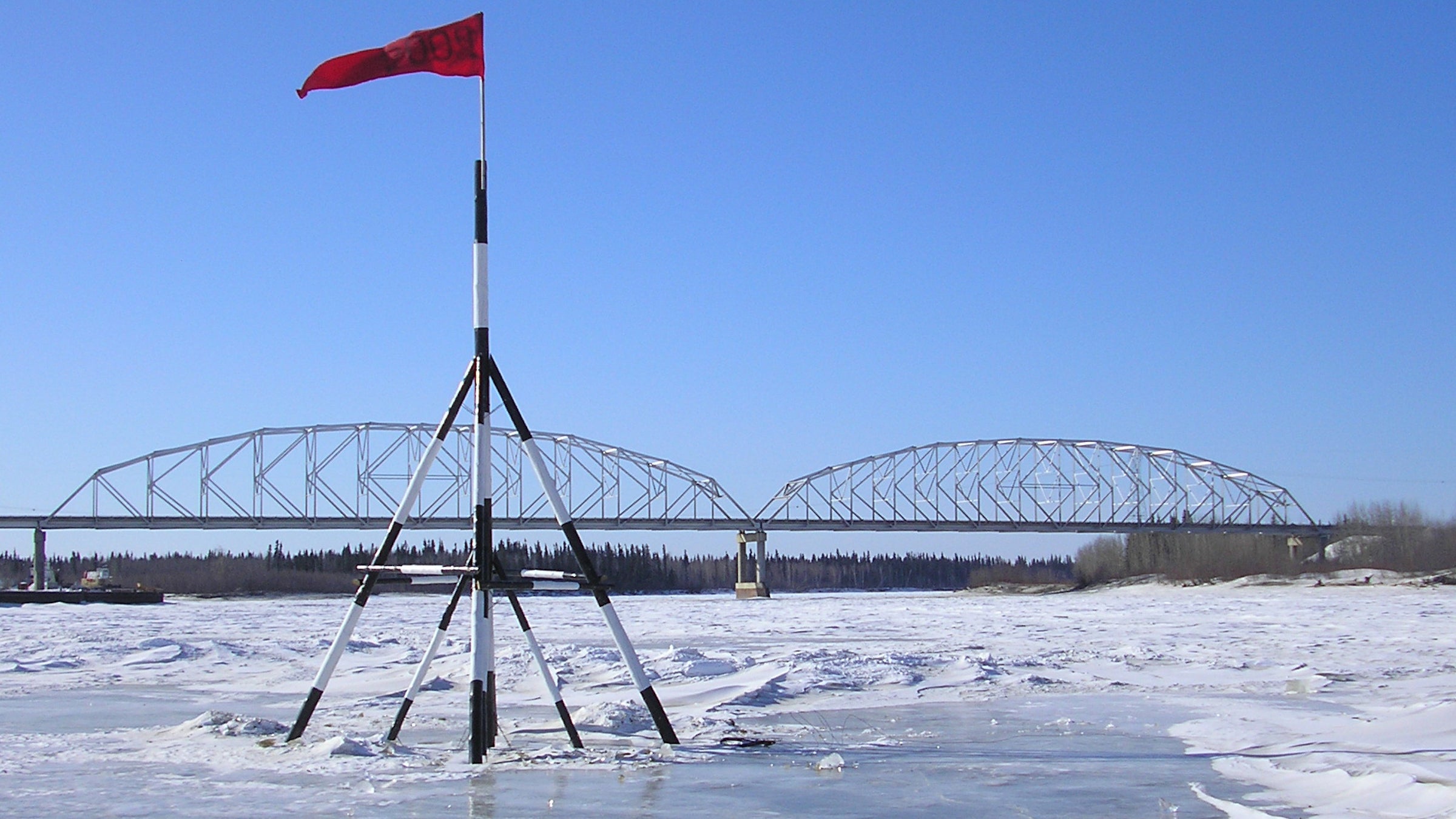 The tripod is always 26 feet tall and made of spruce. It’s always planted in the same spot. And the tripod is hooked up to clock at the end of a 100-foot length of rope.