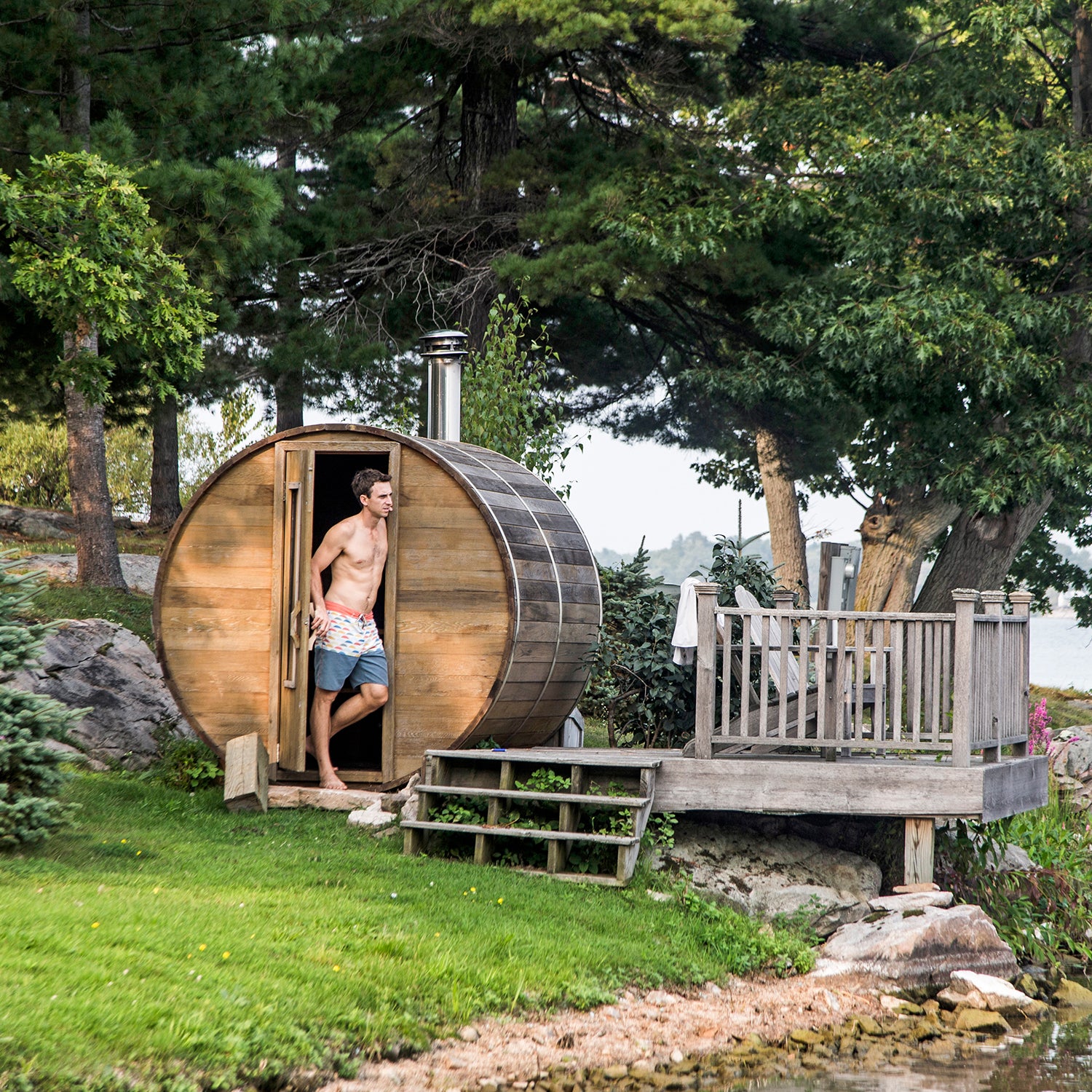 A man stands next to a backyard sauna along the St. Lawrence River in upstate New York's 1000 Islands.