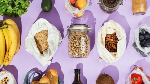 Zero-waste healthy grocery shopping concept:  pulses, fruits, greens and vegetables in mesh net or cotton bags and glass jars