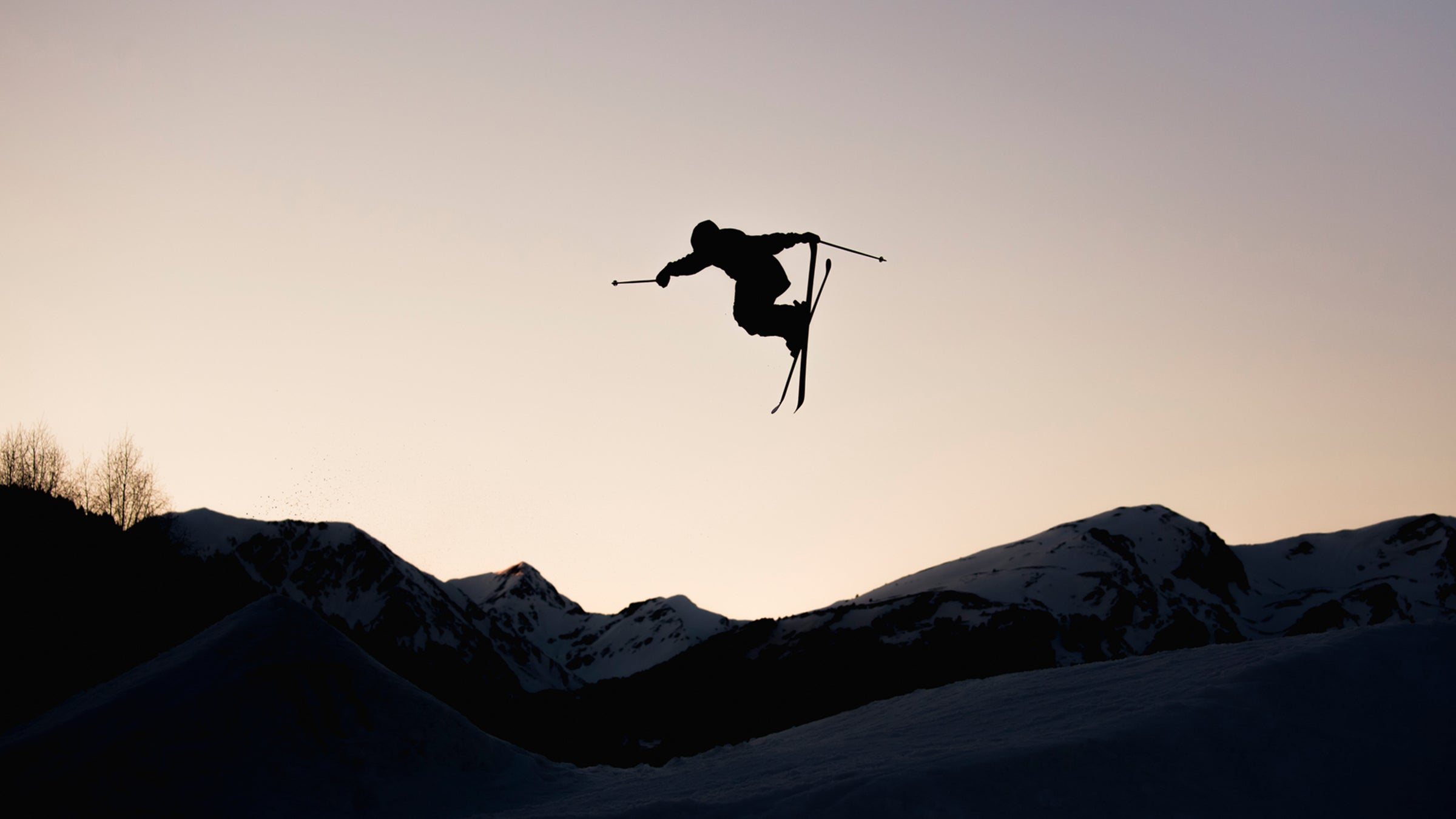 Silhouette Of Skier In Mid-air, From The Big Jump Freestyle At Sunset