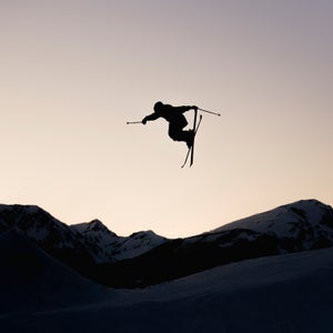 Silhouette Of Skier In Mid-air, From The Big Jump Freestyle At Sunset