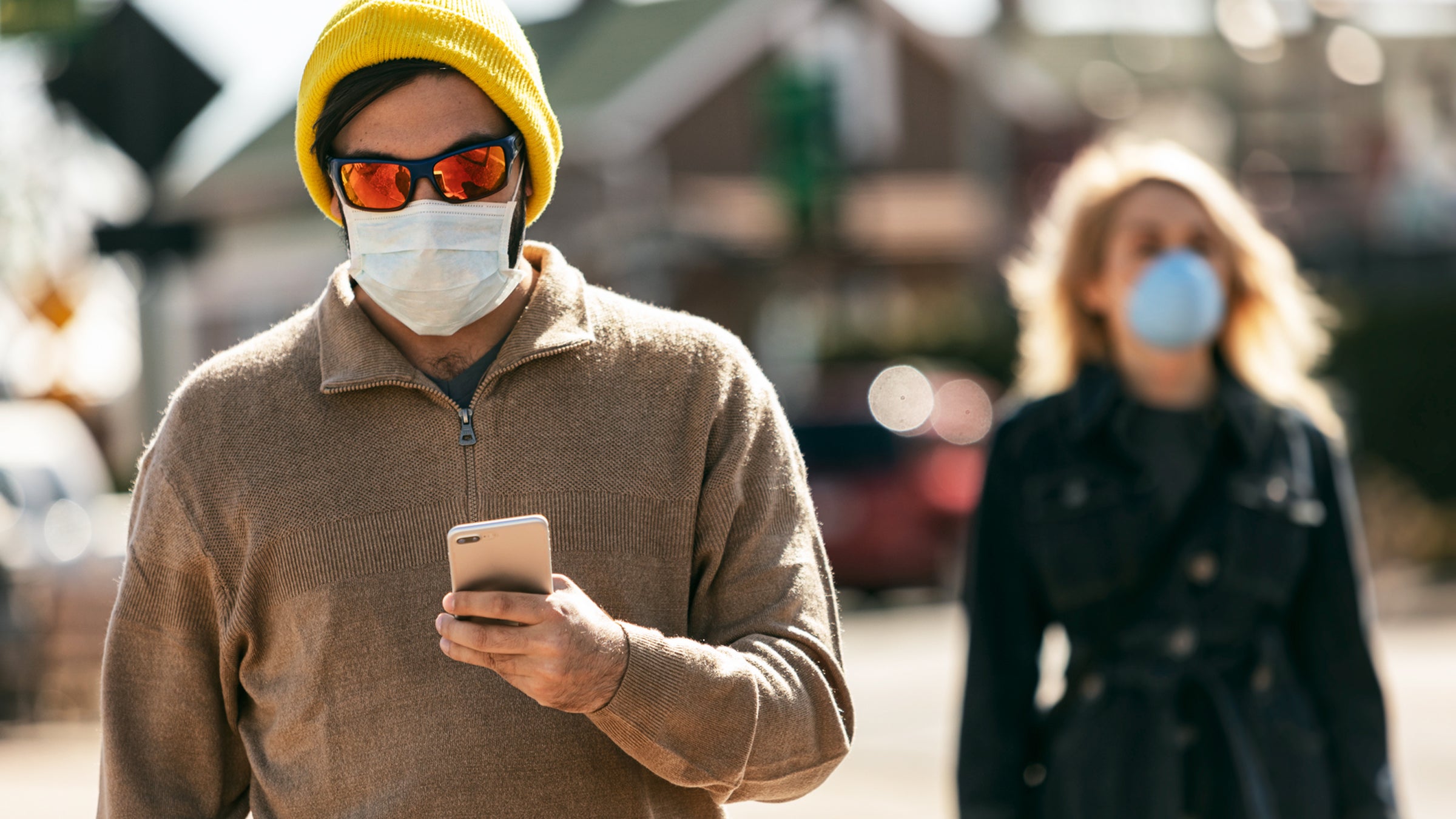 Virus: Hipster Man Walks While Wearing Mask And Using Cell Phone