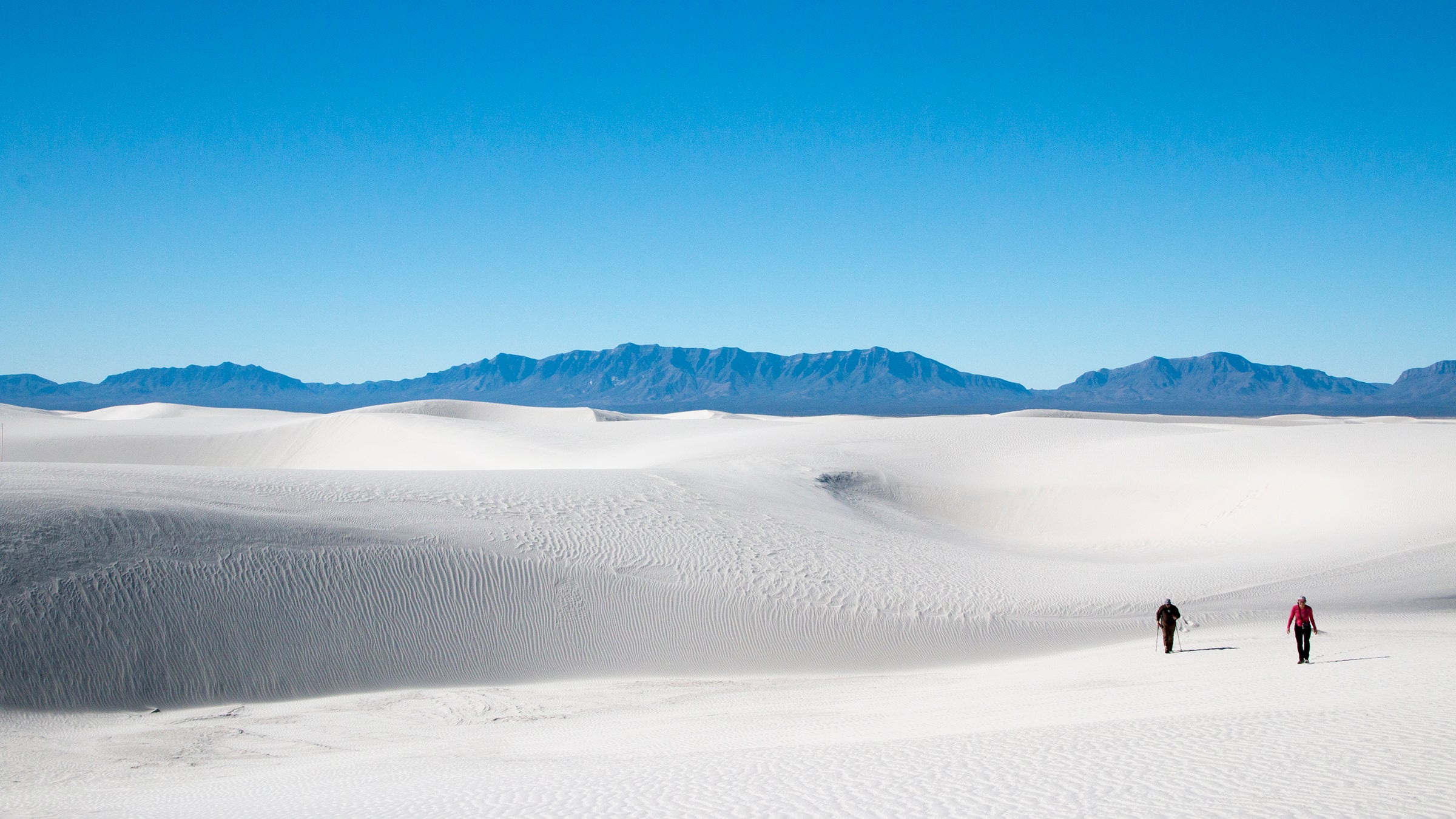 Two hikers in White Sands National Monument. 