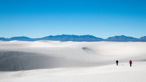 Two hikers in White Sands National Monument.
