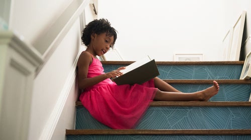 Girl Reading Book In Staircase