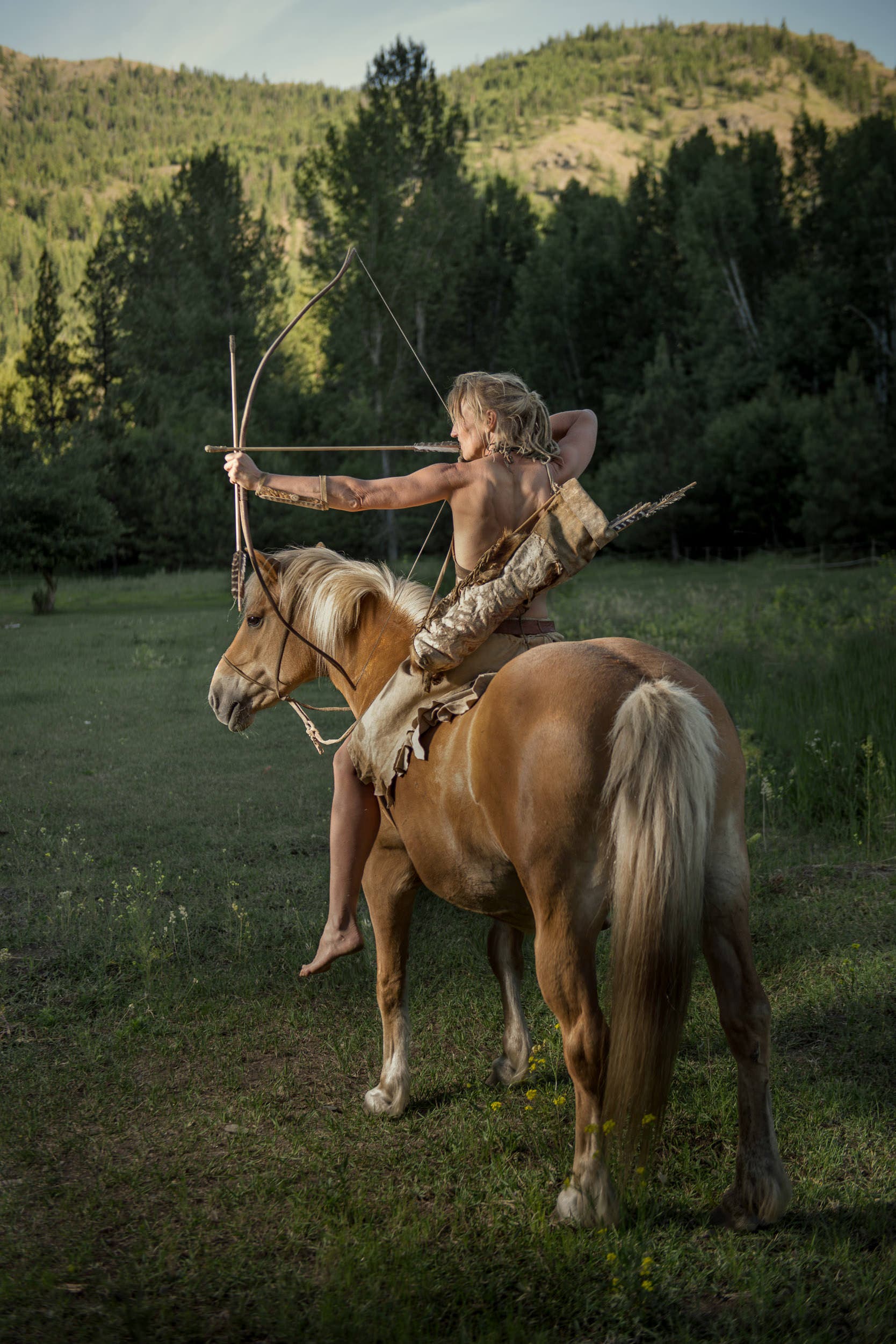 Lynx posing with her handmade bow and arrow