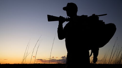 Silhouette of a hunter at sunset