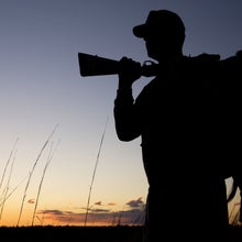 Silhouette of a hunter at sunset