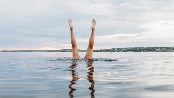 Swimmer Doing Handstands In The Water