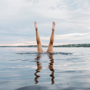 Swimmer Doing Handstands In The Water
