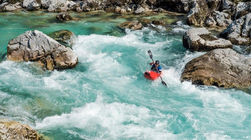 Mature Man Kayaking In White Water Of River Soca