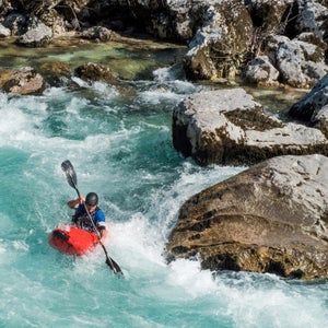 Mature Man Kayaking In White Water Of River Soca